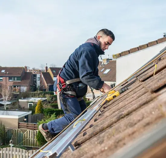 A man working on the roof of his house.